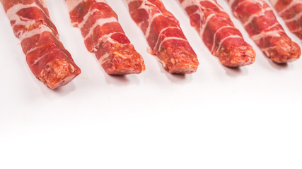 Chevapchichi in bacon isolated on white background.