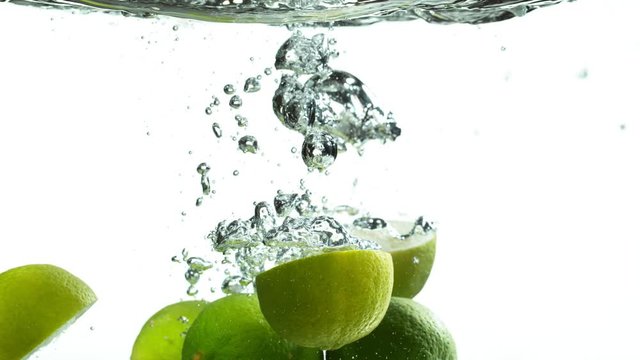 Super slow motion of falling lime isolated on white background with time ramping effect. Filmed on high speed cinema camera, 1000 fps.
