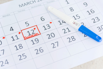Negative pregnancy test with circling date in calendar. Planning of pregnancy, trying to have baby.