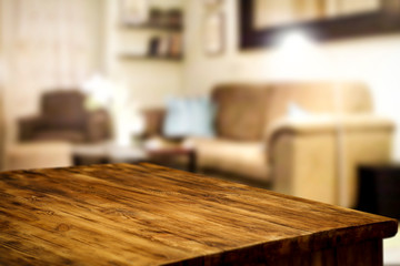 Wooden corner table background of free space for your decoration and blurred home interior 