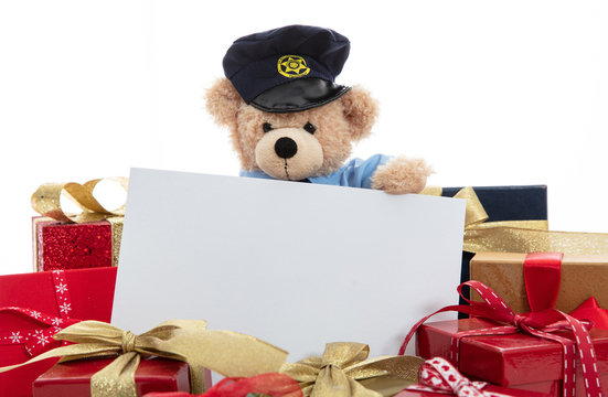 Cute Teddy In Policeman Uniform And Christmas Presents Isolated Against White Background