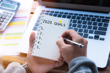 2020 goals concept.Man hands writing on notebook