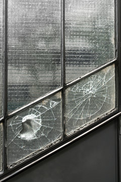 Hole in broken window, abstract background