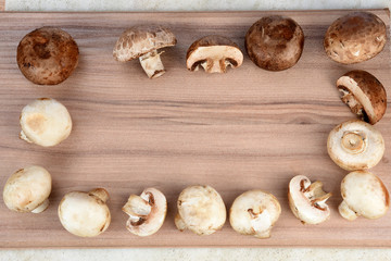 Fresh champignon mushrooms on wooden table, closeup. Space for text