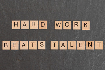 Hark Work Beats Talent Written With Game Tiles
