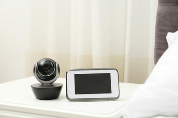 Baby monitor with camera on table in bedroom. Video nanny