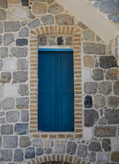 Blue door withing the walls of a Greek Island