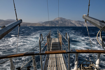 Sea spray from behind a boat near an Island In Greece