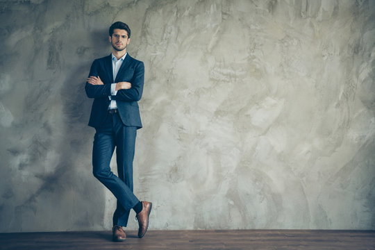 Full length photo of successful masculine businessman with crossed hands standing over grey color background having copyspace wear modern trousers