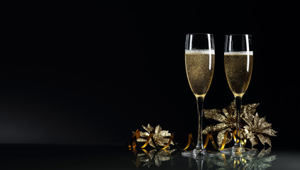Two glasses of champagne ready to bring New Year on a black background. © Igor Normann