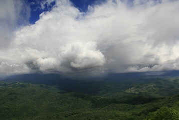 Obraz premium majestic sky with clouds over the green hills. panorama