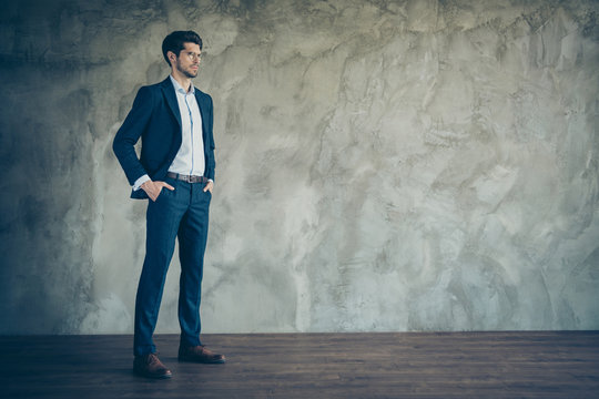 Full size profile side photo of confident cool entrepreneur real expert in his work put hands in trousers pockets standing over grey color background