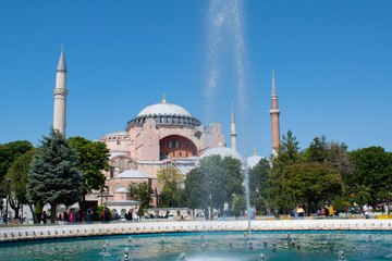 Fototapeta na wymiar Istanbul, Turkey: Hagia Sophia, the famous former Greek Orthodox Christian patriarchal cathedral, later an Ottoman imperial mosque and now a museum, seen through the fountain of Sultan Ahmet Park