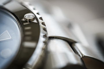 Extreme close-up of the rotating bezel and hour marker seen on an iconic, swiss-made divers watch....