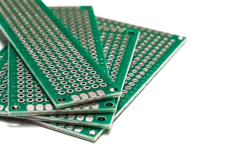Green prototyping board in a pile isolated on white background