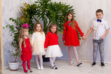 girls and boy in red and white clothes on birthday party