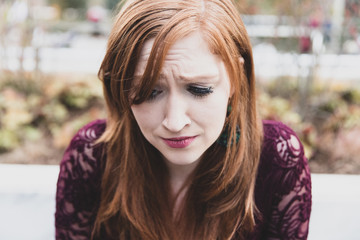 Sad and depressed woman crying outside along