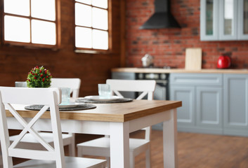 Stylish kitchen interior with dining table and chairs