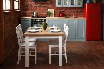 Stylish kitchen interior with dining table and chairs