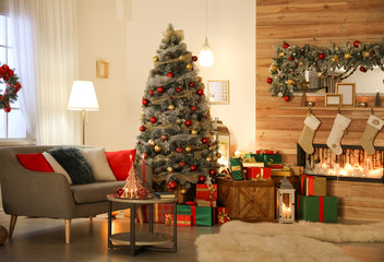 Beautiful living room interior with decorated Christmas tree and fireplace
