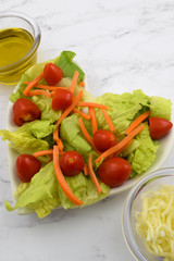 Fresh Salad on Heart Shaped Plate with Toppings