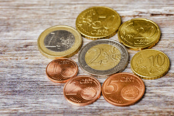 all the European coins lying in a circle on wooden background