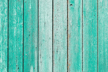 Old and peeling paint Over time, the green paint peeled off from the old boards and the wood texture cracked. Vintage Abstract Grunge Background