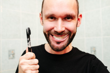 Man snarling at razor with shaving cream and towel