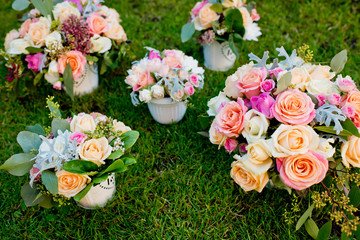 Five different wedding bouquets on a green grass. Close-up.