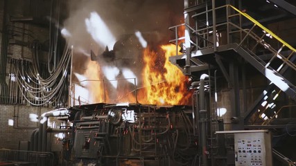 Steel production in a steelmaking furnace. Metallurgy. Casting ingot. Electric arc furnace shop. Shop EAF. Plant for the production of steel. An electric melting furnace. Close up.