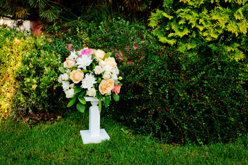 Wedding bouquet on a green grass in the park.