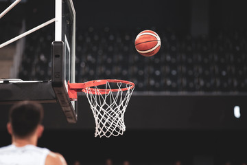 scoring during a basketball game ball in hoop