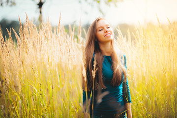 People success freedom concept - Fashion portrait of beautiful smiling young blonde Caucasian  girl women watching with her perfect eyes outdoor in the park wheat field outdoor at summer in sunlight