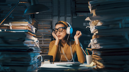Careless employee listening to music instead of working