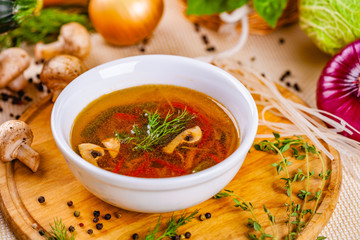 Vegetable soup with herbs and spices in white plate