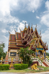 Ko Samui Island, Thailand - March 18, 2019: Wat Laem Suwannaram Chinese Buddhist Temple. Elaborately decorated full of colors side front facade with several statues and paintings.