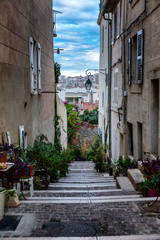 Fototapeta na wymiar Narrow street in the old town of Marseille. Vertical.