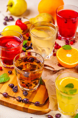 Berry fruit drinks and lemonades on wooden cutting board