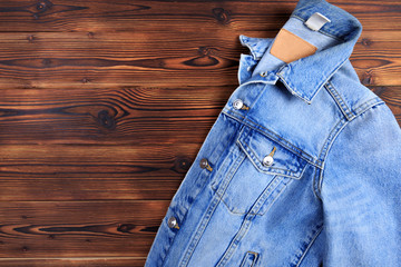 blue denim jean jacket  on wooden background.