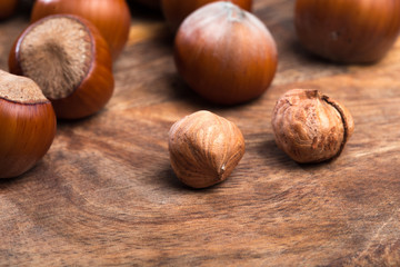 close up of hazelnuts on wooden table .