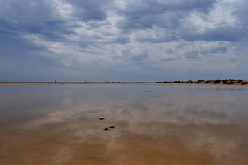 sky reflected in the water of a lagoon