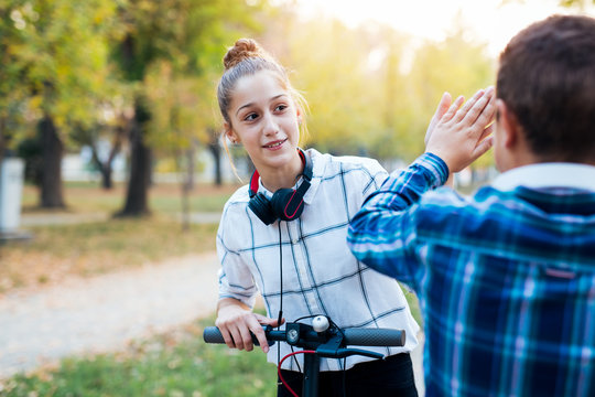 Two Kids Giving Each Other High Five.