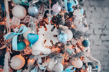 Details of a Christmas decorated tree in dark turquoise and orange colors. New Year and Christmas...