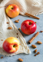 Three red yellow apples on a gray table