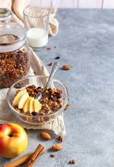 Apple granola with spices for breakfast on a gray table