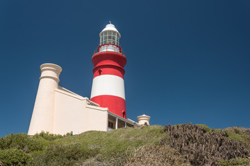 Fototapeta na wymiar Cape Agulhas Lighthouse at the Southernmost tip of Africa, a point along the Garden Route in South Africa
