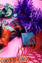 new year party stuff close up in mess on bright pink background, holiday gifts concept