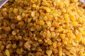 Raising in gold colour close-up for sale at grocery shop.