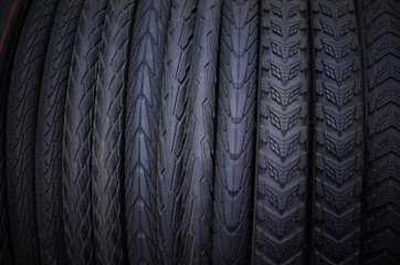 Bike tire in bike shop for sale - row of tyre with different patterns