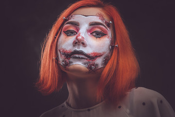 Closeup photo shoot of woman's face with creative scary makeup for Halloween.